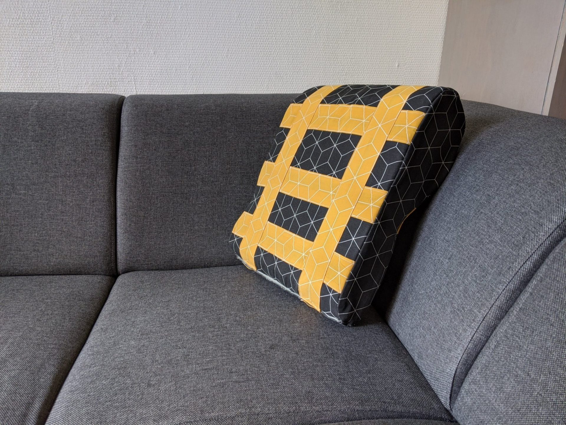 shows the prototype of the pillow on the couch