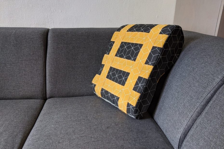 shows the prototype of the pillow on the couch